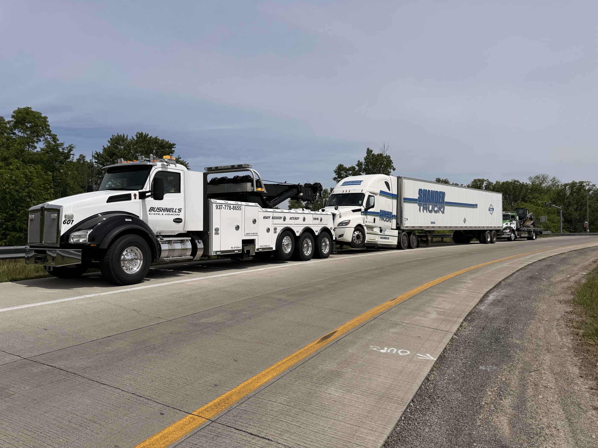 Bushnell's flatbed truck hauling large liquid containers